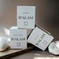 B'ALAM luxury candle packaging on a stone surface with a neutral background